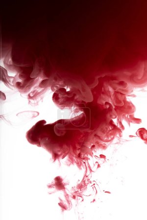 Photo for Red color flowing in smoke forms, smooth abstract moving by acrylic paint - Royalty Free Image