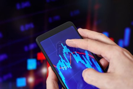 Trader analyzes stock market data in smartphone