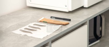 Photo for Ultrasonic cleaner. Preparation of medical tweezers tools for ultrasonic sterilization - Royalty Free Image