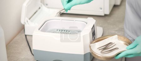 Photo for Hand disinfects tweezers with cleaning systems for medical instruments. Ultrasonic cleaner - Royalty Free Image