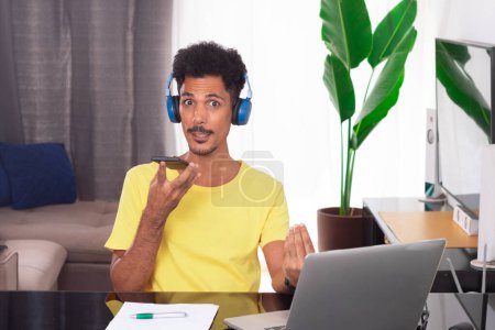 Black Man Wearing Yellow T-shirt at Remote Job. Young Digital Nomad on a Teleworking Meeting at Desk With Laptop