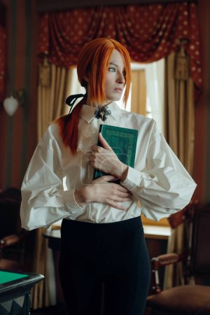 Retro Woman with red hair is engrossed in reading a book