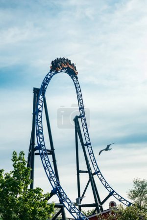 Ride roller coaster in motion on sky background in amusement park