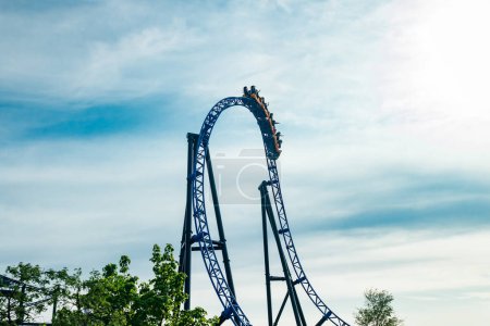 Ride roller coaster in motion on sky background in amusement park