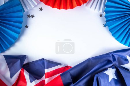 Australia Day greeting card Background with  australian flag, silver stars, paper red, blue, white decor, over white background, frame copy space