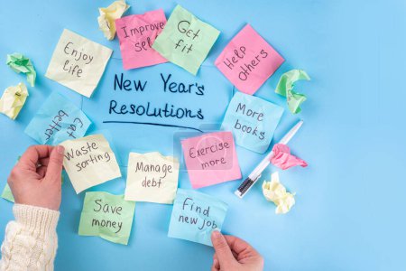 Photo for New year goals or resolutions on bright colorful paper stickers. New Year goals List 2023, plan listing of new year beginnings goals and resolutions setting. Flat lay copy space on blue background - Royalty Free Image