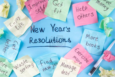 Photo for New year goals or resolutions on bright colorful paper stickers. New Year goals List 2023, plan listing of new year beginnings goals and resolutions setting. Flat lay copy space on blue background - Royalty Free Image