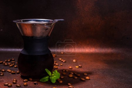 Photo for Chemex handy brew coffee maker, slow and drip brew espresso coffee making device, with coffee beans on dark brown background copy space - Royalty Free Image