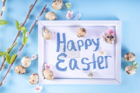Foto de Spring Easter holiday top view background with eggs and willow flowers. Simple Happy Easter  greeting card background with copy space - Imagen libre de derechos