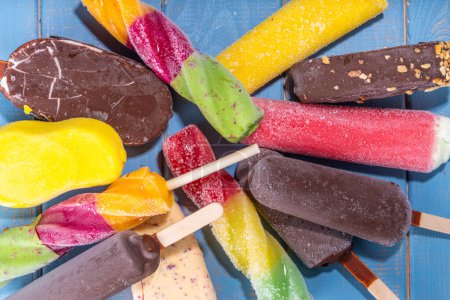 Photo for Various ice cream popsicle on turquoise wooden background, summer sweets, dessert, vacation and holiday background, Set of assorted flavors popsicle lollipops - chocolate, vanilla, fruit, rainbow - Royalty Free Image