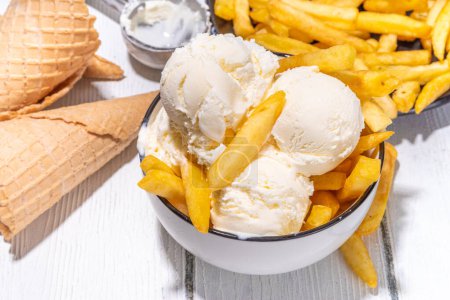Trendy french fries ice cream, Vanilla icecream with original french fries potato flavor, white wooden background copy space