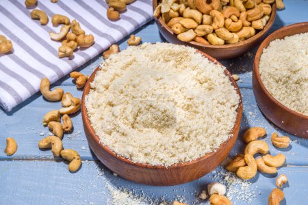 Photo for Alternative keto diet gluten grain free flour. Paleo and ketogenic diet baking cooking concept. Cashew flour with whole nuts - Royalty Free Image