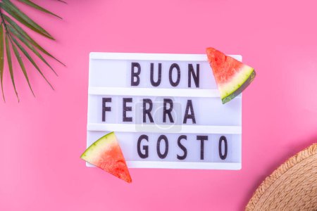 Photo for Buon Ferragosto (Happy Ferragosto) greeting card, holiday background, Italian harvest festival August 15, with lightbox text Buon Ferragosto, watermelon, summer accessories top view copy space - Royalty Free Image