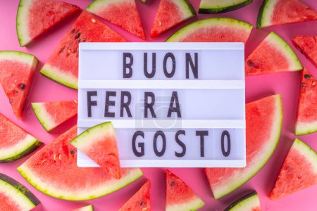 Photo for Buon Ferragosto (Happy Ferragosto) greeting card, holiday background, Italian harvest festival August 15, with lightbox text Buon Ferragosto, watermelon, summer accessories top view copy space - Royalty Free Image