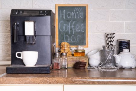 Home Coffee Station, Coffee Bar. Küche Kaffeecke mit Kaffeemaschine, Kaffeebohnen, Tee, Süßigkeiten und Belag für Getränke