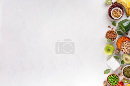 Portfolio Diet, balanced lowering cholesterol vegan food, including nuts, vegetable protein, plant sterols, viscous fiber, beans, legumes, fresh vegetables and fruits on white background copy space