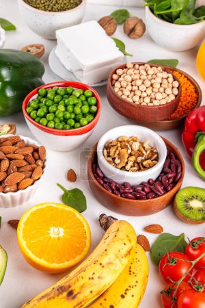 Portfolio Diet, balanced lowering cholesterol vegan food, including nuts, vegetable protein, plant sterols, viscous fiber, beans, legumes, fresh vegetables and fruits on white background copy space
