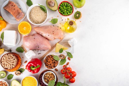Clean Eating Diet foods background, fruits, vegetables, lean proteins, whole grains and healthy fats, nuts, legumes, chicken meat, fresh fish, beans on white background. Balanced healthy flat lay