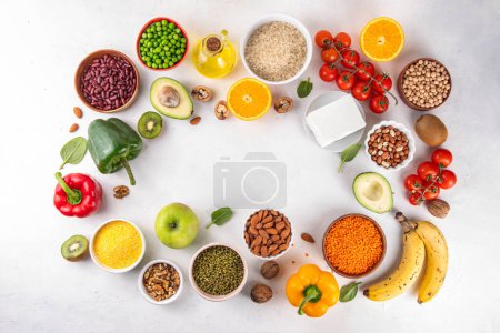 Photo for Portfolio Diet, balanced lowering cholesterol vegan food, including nuts, vegetable protein, plant sterols, viscous fiber, beans, legumes, fresh vegetables and fruits on white background copy space - Royalty Free Image