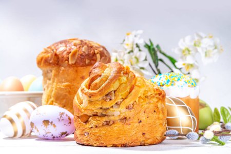 Easter background with baking cruffin pandoro pannetone cake, with colorful painted Easter eggs. Happy Easter greeting card background