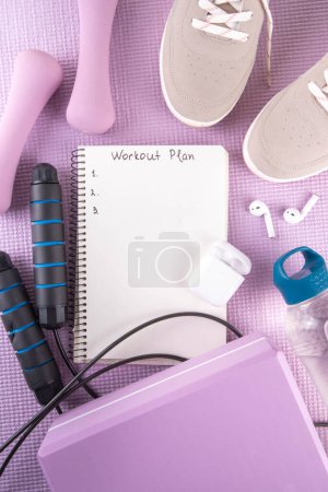 Sport and fitness, home workout plan background. Spring weight loss, slimming concept. Yoga mat and brick, dumbbells, bottle of water, headphones for sports music flat lay copy space top view
