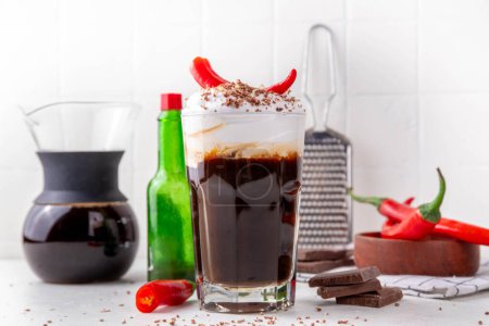 Photo for Hot spicy coffee latte with chili pepper, whipped cream and chocolate chips on top, copy space - Royalty Free Image