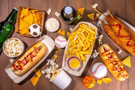 Traditional sport stadium foods and beer background, Set of various baseball, basketball, football fans and stadium snacks, chips, sauces, hot dogs with beer bottles and fan accessories 