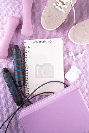 Sport and fitness, home workout plan background. Spring weight loss, slimming concept. Yoga mat and brick, dumbbells, bottle of water, headphones for sports music flat lay copy space top view