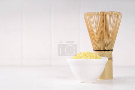 Dry yellow matcha powder. Yellow matcha with mango extract, for making fruity healthy matcha tea  drinks on white background copy space