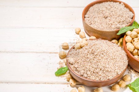 Alternative keto diet gluten grain free flour. Paleo and ketogenic diet baking cooking concept. Hazelnut flour with whole nuts
