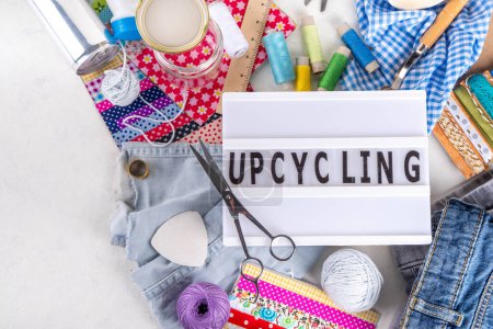 DIY upcycling ideas and materials background. Sustainable hobby with handmade, ecology creative reusable hand made with plastic bottles, metal cans, old jeans, fabrics, glass containers, top view