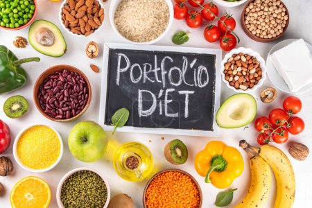 Photo for Portfolio Diet, balanced lowering cholesterol vegan food, including nuts, vegetable protein, plant sterols, viscous fiber, beans, legumes, fresh vegetables and fruits on white background copy space - Royalty Free Image