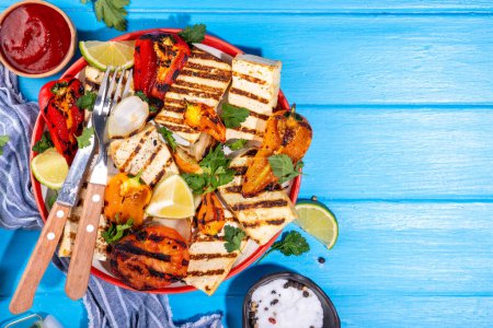 Summer vegan barbeque recipe. BBQ healthy balanced vegetarian food, grilled roasted tofu cheese steaks with vegetables, 