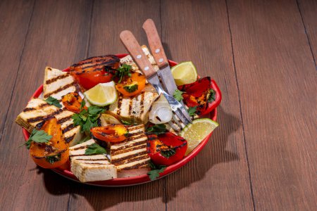 Summer vegan barbeque recipe. BBQ healthy balanced vegetarian food, grilled roasted tofu cheese steaks with vegetables, 