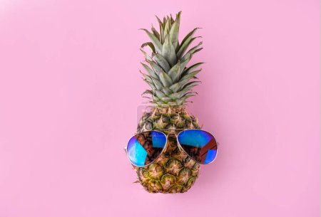 Creative summer vacation, party and holiday background with pineapple in sunglasses and headphones, summer music, recreation vibe concept