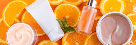 Orange citrus Vitamin C face care - cream, serum. mask, face cleaner, antioxidant moisturizer skin face care and make up concept, with fresh orange fruit slices