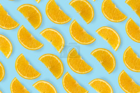 Photo for Citrus orange halves cut pieces slices on a blue bright background, flat lay top view pattern - Royalty Free Image