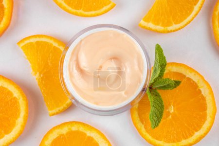 Photo for Orange citrus Vitamin C face care - cream, serum. mask, face cleaner, antioxidant moisturizer skin face care and make up concept, with fresh orange fruit slices - Royalty Free Image