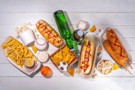 Traditional sport stadium foods and beer background, Set of various baseball, basketball, football fans and stadium snacks, chips, sauces, hot dogs with beer bottles and fan accessories 
