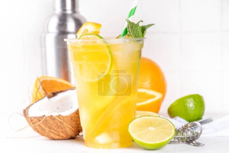Orange coconut lemonade mojito drink, summer iced cocktail, mocktail with fresh fruit and juices