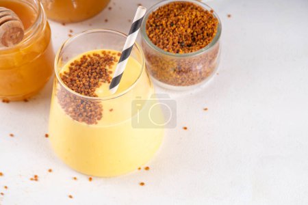 Bee pollen dish, creamy warm or cold shake smoothie golden colored drink