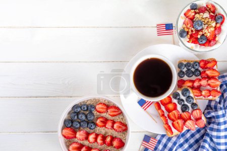 USA patriotic breakfast or brunch with american flag decorated oatmeal, layered yogurt granola dessert, toast sandwiches with fresh berries, and coffee cup on kitchen garden table