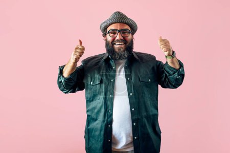 Photo for Fat man with a beard and doing the up sign. - Royalty Free Image
