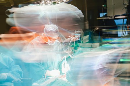 Foto de Photographic double exposure of the doctors working in the operating room. - Imagen libre de derechos