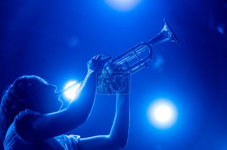 Photo for Woman playing the trumpet at a live concert. - Royalty Free Image