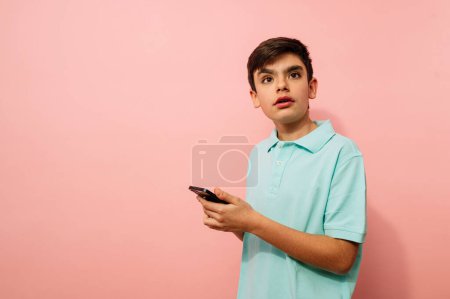 Photo for Young guy using smartphone in studio. - Royalty Free Image