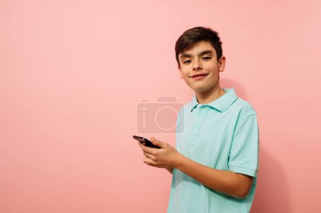 Photo for Young guy using smartphone in studio. - Royalty Free Image