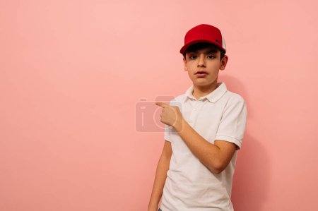 Photo for Young guy pointing aside in studio. - Royalty Free Image