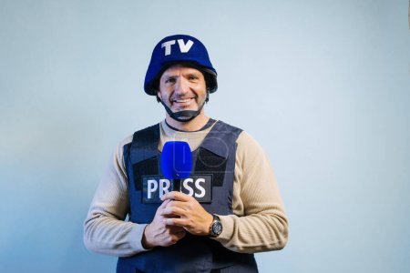 Photo for Reporter with bulletproof vest holding a microphone in studio. - Royalty Free Image