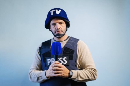 Photo for Reporter with bulletproof vest holding a microphone in studio. - Royalty Free Image